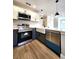Well-equipped kitchen with stainless steel appliances, white cabinets, granite countertops and farmhouse sink at 4050 Pacific Harbors Dr # 209, Las Vegas, NV 89121