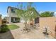 Serene backyard featuring gravel landscaping, an ornamental tree, and a cozy seating area visible through sliding glass doors at 410 Gracious Way, Henderson, NV 89011