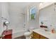 Clean bathroom featuring a shower-tub combo, a sink with a vanity, and a window for natural light at 410 Gracious Way, Henderson, NV 89011