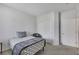 Minimalist bedroom with a twin bed, a closet, and a chair, offering a simple and clean aesthetic at 410 Gracious Way, Henderson, NV 89011