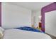 Bright bedroom featuring a white bedspread, blue throw, and access to an ensuite bathroom at 410 Gracious Way, Henderson, NV 89011