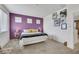 Large bedroom with a plush carpet and purple accent wall at 410 Gracious Way, Henderson, NV 89011