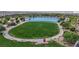 Aerial view of a beautiful community park featuring a lake, walking paths, and a large grassy area at 410 Gracious Way, Henderson, NV 89011