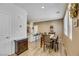Cozy dining area with modern table, natural light, and seamless connection to kitchen area at 410 Gracious Way, Henderson, NV 89011