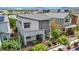 Aerial view of a modern two-story home with manicured landscaping, a front porch, and a black metal fence at 410 Gracious Way, Henderson, NV 89011