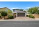 A modern two-story home features a brick driveway, a two-car garage, and well-manicured landscaping at 410 Gracious Way, Henderson, NV 89011