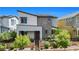 Contemporary two-story home featuring desert landscaping, dark trim, and a welcoming entryway at 410 Gracious Way, Henderson, NV 89011