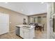 Well-lit kitchen featuring stainless steel appliances, an island with a sink, and a dining area at 410 Gracious Way, Henderson, NV 89011
