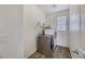 A well-lit laundry room featuring a modern washer and dryer set with tile flooring at 410 Gracious Way, Henderson, NV 89011