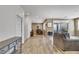Open floor plan with wood-look tile, eat-in kitchen, comfortable living room, and sliding glass door at 410 Gracious Way, Henderson, NV 89011