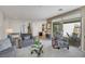 Open-concept living room with modern decor, neutral tones, and seamless transition to outdoor patio at 410 Gracious Way, Henderson, NV 89011