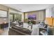 Comfortable living room with modern decor, plush seating, and sliding glass doors to outdoor area at 410 Gracious Way, Henderson, NV 89011