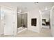 Modern bathroom features a glass shower and tile flooring, next to a bedroom view at 4148 Campriani Ave, North Las Vegas, NV 89084