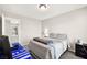 Bedroom with a gray bedspread, a desk setup, and a view of the hallway at 4148 Campriani Ave, North Las Vegas, NV 89084