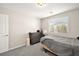 Bedroom with a gray bedspread, furnishings, and natural light from the window at 4148 Campriani Ave, North Las Vegas, NV 89084