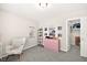 Cozy bedroom featuring carpet floors, a comfortable chair, and a closet with ample storage at 4148 Campriani Ave, North Las Vegas, NV 89084