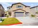 Charming two-story home with neutral paint, gray shutters, stone accents, and a three-car garage at 4148 Campriani Ave, North Las Vegas, NV 89084