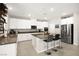 Bright kitchen with stainless steel appliances, white cabinets, and an island with bar stool seating at 4148 Campriani Ave, North Las Vegas, NV 89084