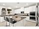 Modern kitchen featuring an island, white cabinetry, stainless steel appliances, and granite countertops at 4148 Campriani Ave, North Las Vegas, NV 89084