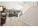 Bright living room with stairs, tile floors, and natural light streaming through large windows at 4148 Campriani Ave, North Las Vegas, NV 89084