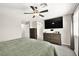 Large main bedroom with mounted TV, ceiling fan, and closet access at 4148 Campriani Ave, North Las Vegas, NV 89084