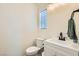 Cozy bathroom with white vanity, toilet and window at 4634 English Lavender Ave, North Las Vegas, NV 89031