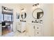 Bathroom featuring double sinks, round mirrors, and view into the bedroom at 4634 English Lavender Ave, North Las Vegas, NV 89031