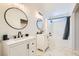 Bright bathroom featuring dual sinks, modern fixtures, and a combined shower and tub at 4634 English Lavender Ave, North Las Vegas, NV 89031