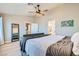 Spacious bedroom with decoratively carved headboard, ceiling fan, and an ensuite bathroom at 4634 English Lavender Ave, North Las Vegas, NV 89031
