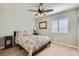 Bedroom featuring wood laminate flooring, a ceiling fan, and a window providing natural light at 4634 English Lavender Ave, North Las Vegas, NV 89031