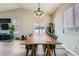 Bright dining room with hardwood floors and long table with view of the backyard at 4634 English Lavender Ave, North Las Vegas, NV 89031