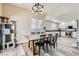 Open dining area with stylish light fixture, connecting kitchen with stainless steel appliances at 4634 English Lavender Ave, North Las Vegas, NV 89031