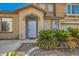 Home's inviting front entrance, accented with desert landscaping and shuttered windows at 4634 English Lavender Ave, North Las Vegas, NV 89031
