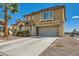 Two-story home featuring a spacious driveway, two-car garage, and desert-style landscaping at 4634 English Lavender Ave, North Las Vegas, NV 89031