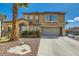 Two-story home with desert landscaping, two-car garage, and front yard palm tree at 4634 English Lavender Ave, North Las Vegas, NV 89031