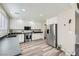 Modern kitchen with stainless steel appliances, white cabinets, and wood-look flooring at 4634 English Lavender Ave, North Las Vegas, NV 89031