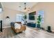 Charming living room with hardwood floors, leather sofa, built in shelves, and high ceilings at 4634 English Lavender Ave, North Las Vegas, NV 89031