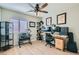 Office featuring wood laminate flooring, a ceiling fan, and a window providing natural light at 4634 English Lavender Ave, North Las Vegas, NV 89031