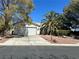Charming single-Gathering home featuring a well-manicured front yard with mature trees at 5000 Burr Oak Dr, Las Vegas, NV 89130