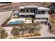 Elevated view of modern home with pool, spa, covered outdoor living area, and multiple levels of outdoor patios at 505 Dragon Gate Ct, Henderson, NV 89012