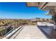 Large tiled balcony offers panoramic views of the city skyline and a glimpse of a luxurious pool at 505 Dragon Gate Ct, Henderson, NV 89012