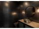 Stylish powder room featuring modern fixtures and a sleek design, complete with dark tiling at 505 Dragon Gate Ct, Henderson, NV 89012