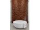Relax in this bathroom featuring a modern soaking tub and wood accent wall at 505 Dragon Gate Ct, Henderson, NV 89012