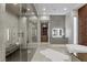 A luxury bathroom features a spacious shower, soaking tub and custom cabinets at 505 Dragon Gate Ct, Henderson, NV 89012