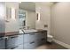 Modern bathroom with a floating vanity, a vessel sink, and unique wall sconces at 505 Dragon Gate Ct, Henderson, NV 89012