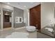 This bathroom features a soaking tub, dual sink vanities, and custom cabinets at 505 Dragon Gate Ct, Henderson, NV 89012