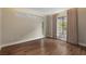 Bright bedroom with hardwood floors, neutral walls, and large windows with lush green views and contemporary blinds at 505 Dragon Gate Ct, Henderson, NV 89012