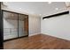 Inviting bedroom with hardwood floors, large glass sliding door, shiplap wall, and recessed lighting at 505 Dragon Gate Ct, Henderson, NV 89012