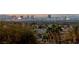 Enjoy the spectacular Las Vegas skyline views from this home, surrounded by trees and lush landscape at 505 Dragon Gate Ct, Henderson, NV 89012
