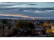 Enjoy stunning city views from this property, showcasing the Las Vegas skyline against a dramatic twilight sky at 505 Dragon Gate Ct, Henderson, NV 89012